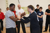 Grandmaster Sergio demonstrates a Wing Chun technique on a student